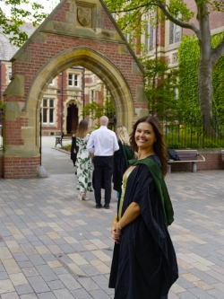 Maddie  waits her turn for a snap under 'the' arch.